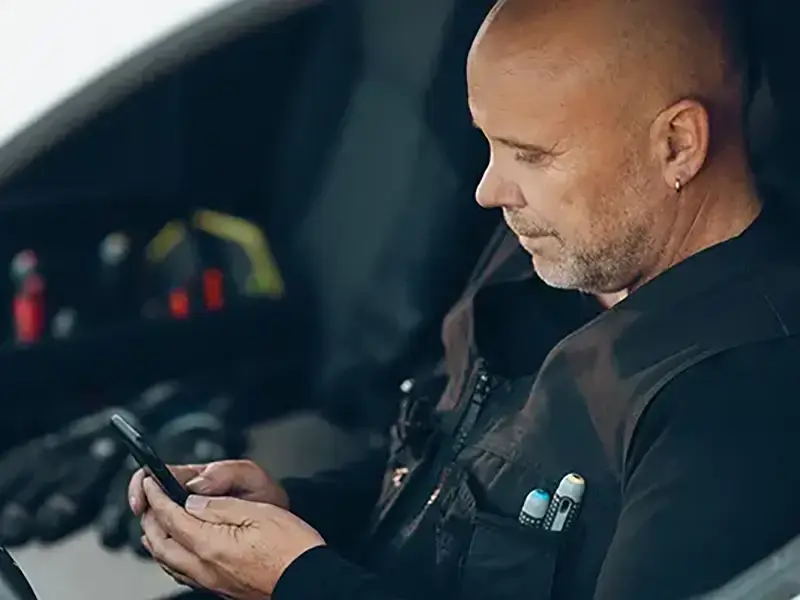 Mand i bil med telefon